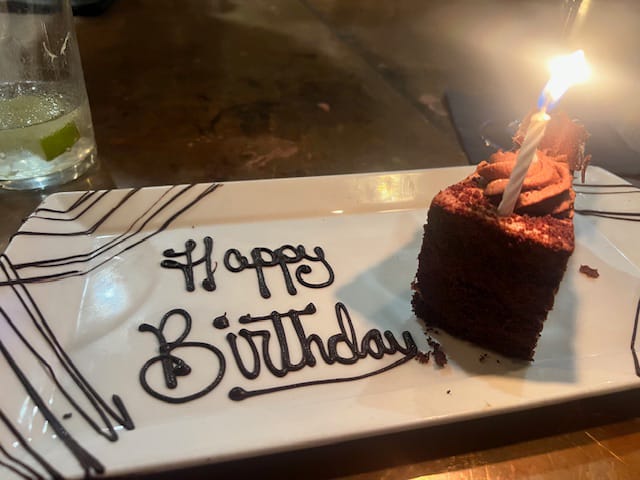 Happy Birthday chocolate cake with a single candle at Rappahannock